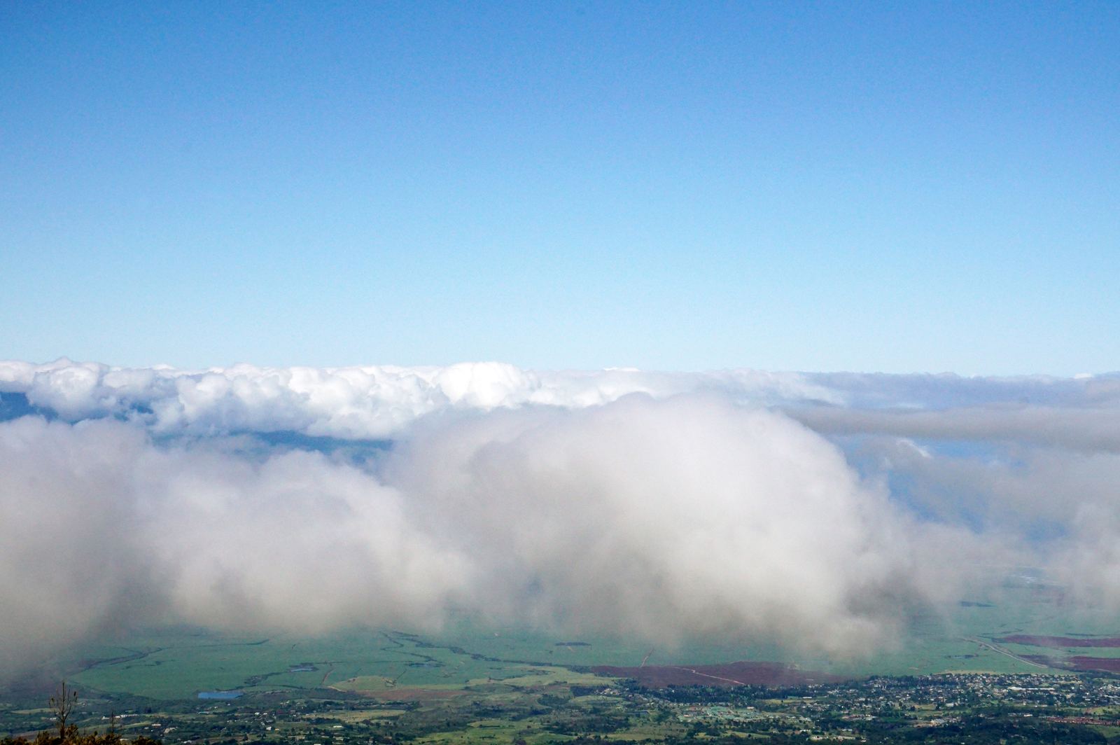 Maui valley seen from above the clouds — the island revealing itself slowly